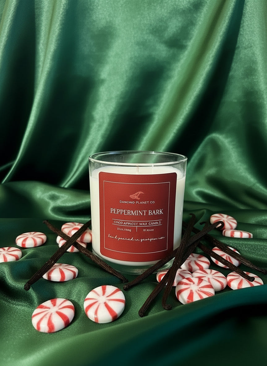 Candle with a red label on a green fabric background