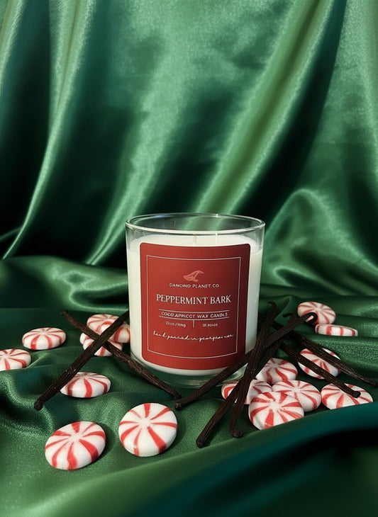 Candle with a red label on a green fabric background