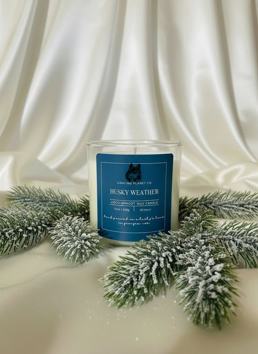 Candle with a blue label on a white fabric background